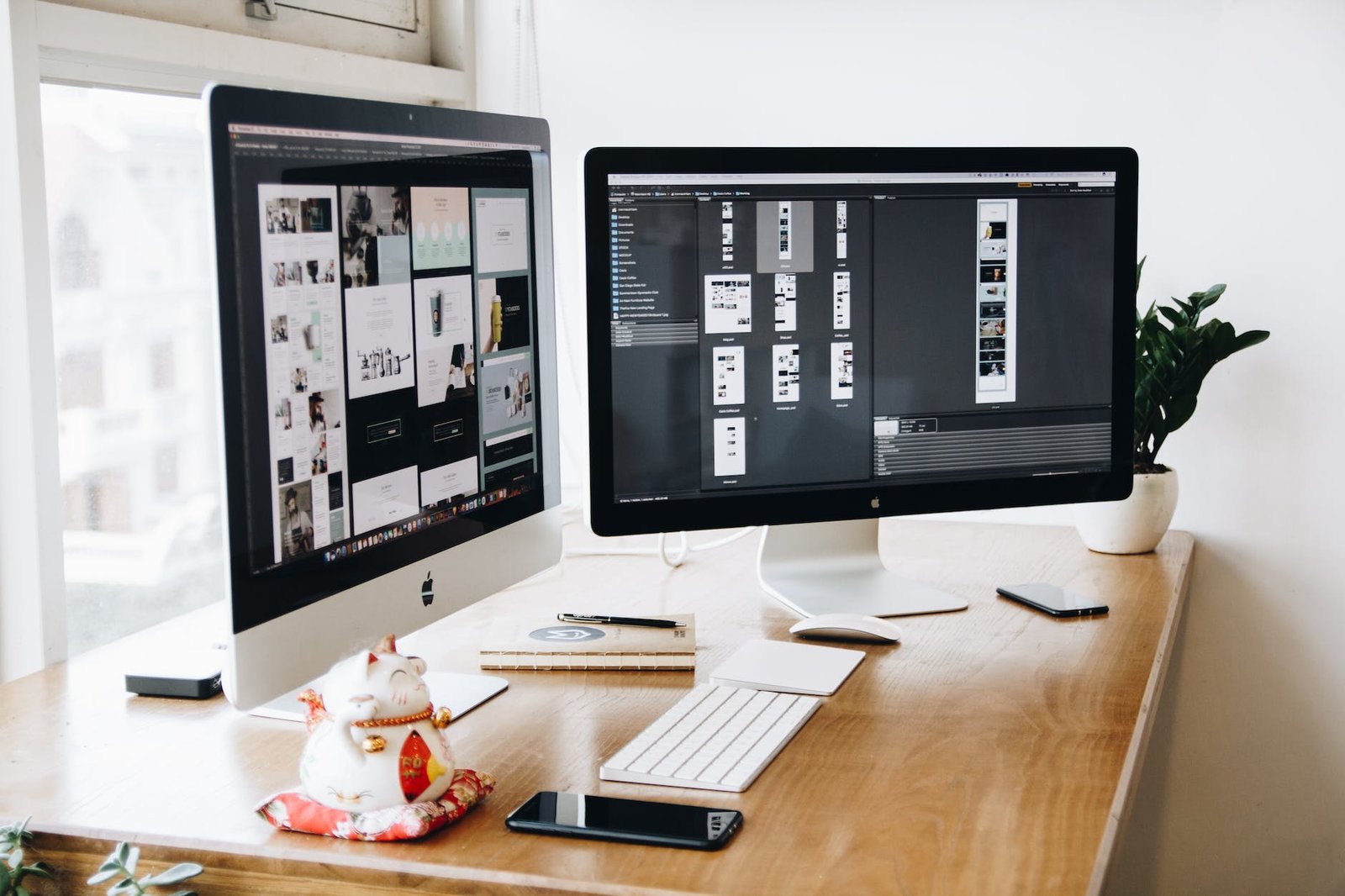 two imac s with keyboard and phones on desk Hosting 