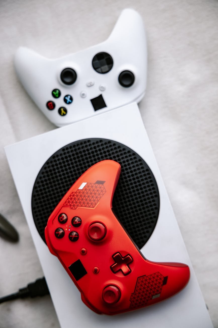 red and white xbox wireless controllers in close up photography