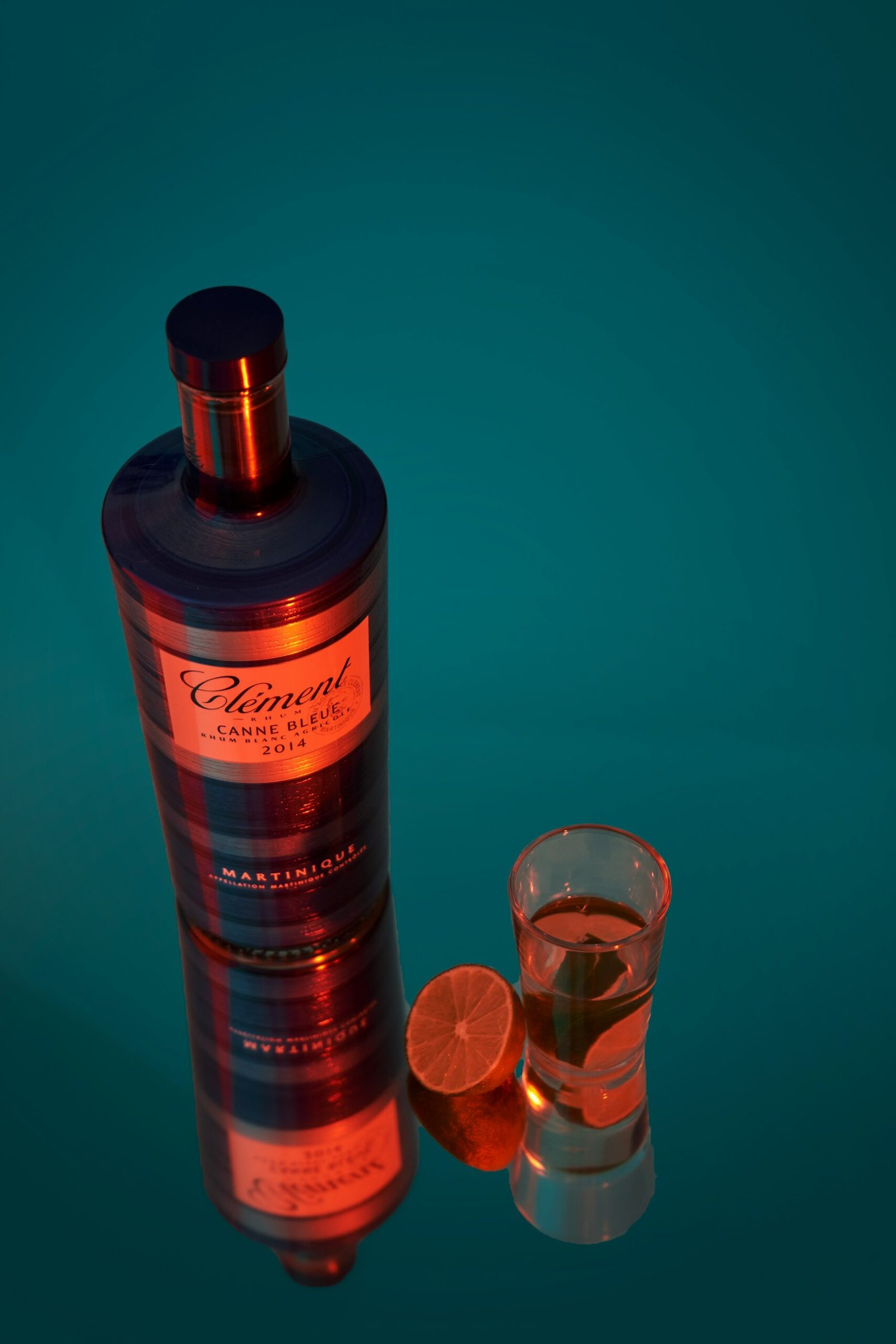 a bottle of liquor next to a shot glass