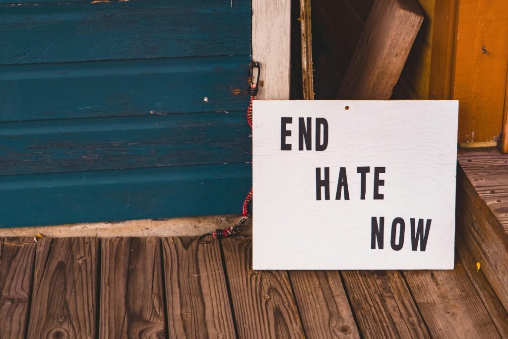 a sign that says end hate now on a porch