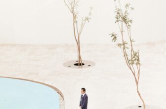 man standing near two trees at daytime