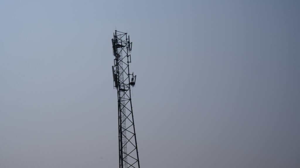 a tall tower with a cell phone on top of it