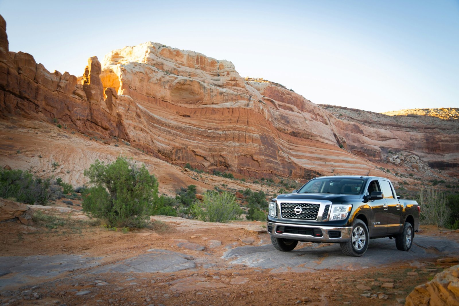 a black truck parked in front of a mountain