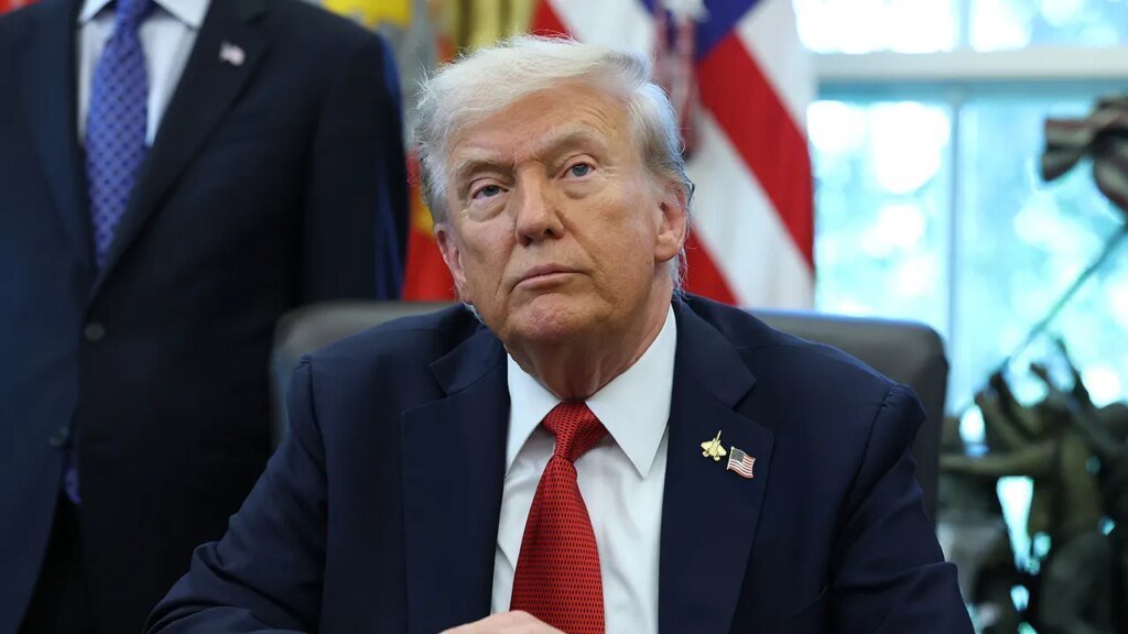 Trump recent oval office sitting hands clasped.jpg