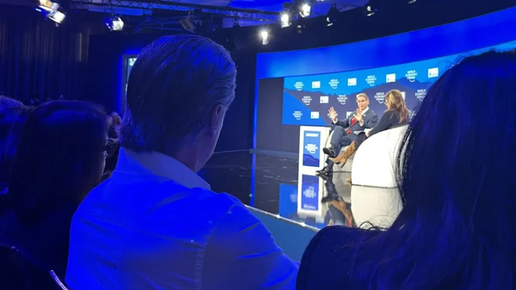 Gavin Newsom Slides Up to Front Row Of Trump Treasury Sec’s Davos Talk and Trolls Him Throughout