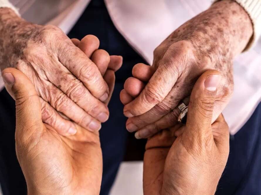 Person holding senior hands longevity.jpg